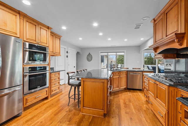 6932 Westview Dr, Oak Forest, IL 60452 - kitchen with a breakfast bar area, stainless steel appliances, recessed lighting, and light wood-style floors