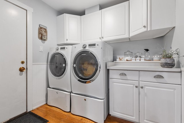 6932 Westview Dr, Oak Forest, IL 60452 - laundry room featuring light wood-style flooring, cabinet space, washing machine and dryer, and wainscoting