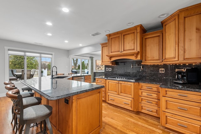 6932 Westview Dr, Oak Forest, IL 60452 - kitchen featuring brown cabinets, a sink, light wood-style flooring, recessed lighting, and backsplash