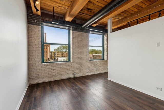 spare room with track lighting, brick wall, beamed ceiling, baseboards, and wood ceiling
