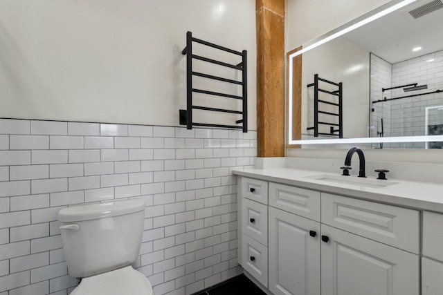 full bathroom featuring visible vents, vanity, toilet, tile walls, and a tile shower