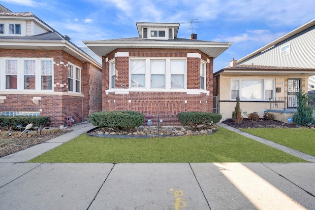 bungalow-style home with a front lawn and brick siding