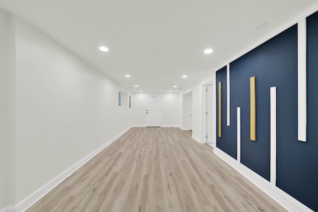 interior space featuring recessed lighting, baseboards, and light wood finished floors