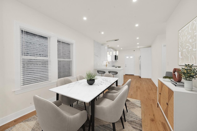 dining area with recessed lighting, baseboards, visible vents, and light wood finished floors