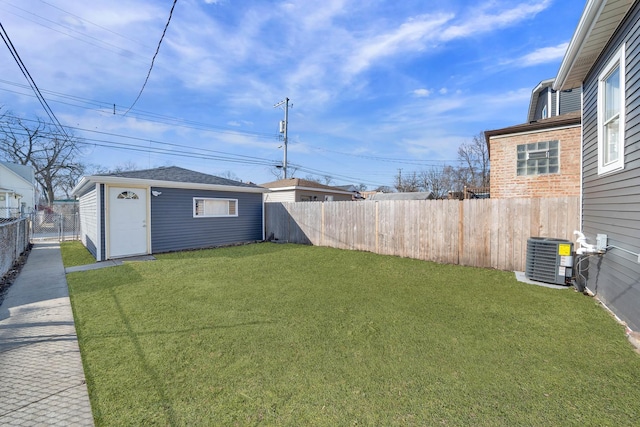 view of yard with an outdoor structure, a fenced backyard, and central air condition unit
