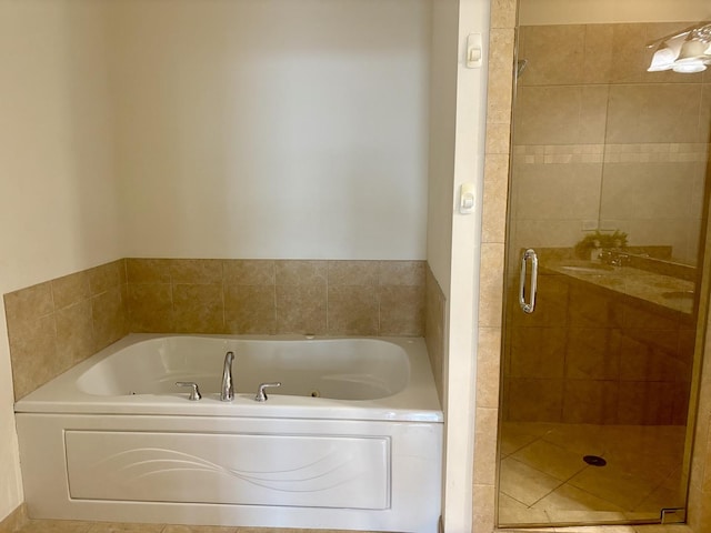 bathroom featuring a shower stall and a garden tub