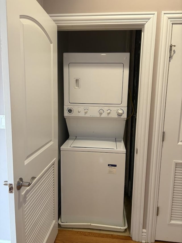 laundry room with stacked washing machine and dryer