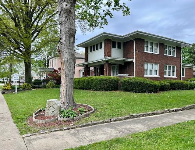229 E Jefferson St, Arcola, IL 61910 - view of front of property featuring a front yard and brick siding