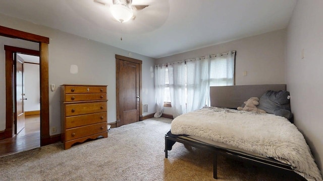 229 E Jefferson St, Arcola, IL 61910 - carpeted bedroom with baseboards and a ceiling fan