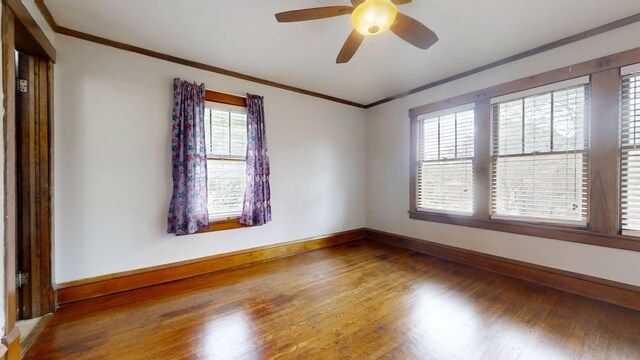 229 E Jefferson St, Arcola, IL 61910 - spare room with wood finished floors, baseboards, ceiling fan, and ornamental molding
