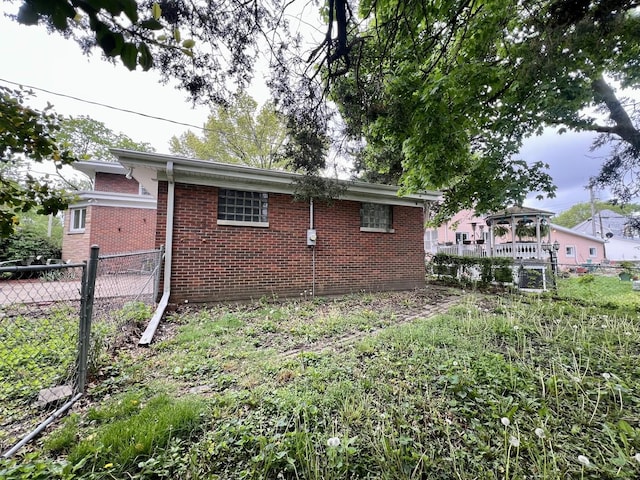 229 E Jefferson St, Arcola, IL 61910 - view of property exterior with brick siding and fence