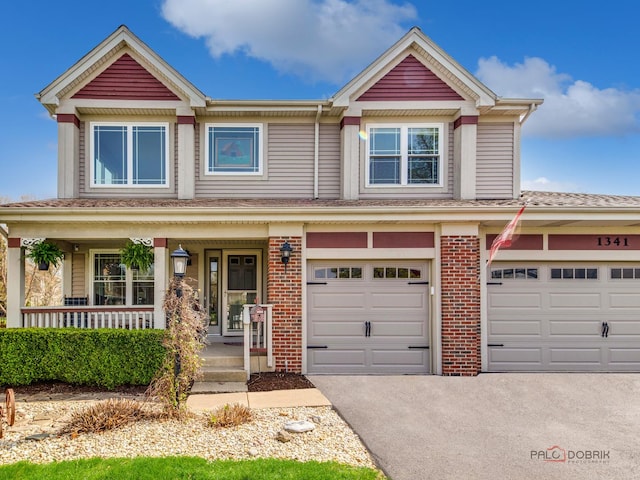 1341 N Home Ct, Palatine, IL 60074 - view of front of home with a porch, driveway, brick siding, and a garage