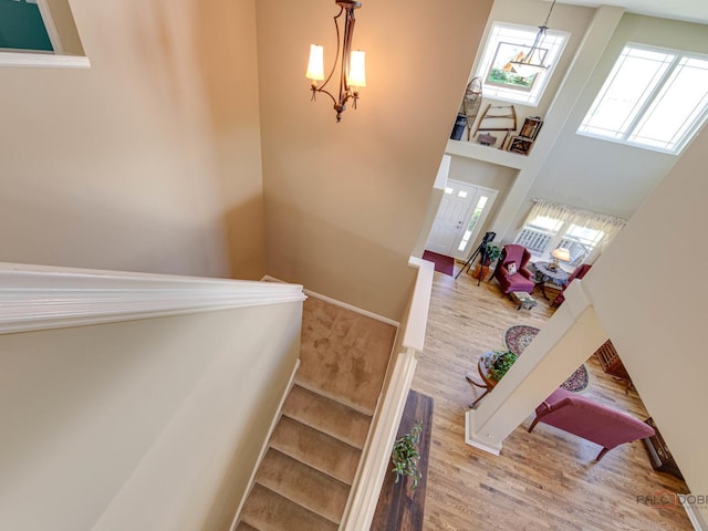 1341 N Home Ct, Palatine, IL 60074 - stairs with wood finished floors, a chandelier, and a high ceiling