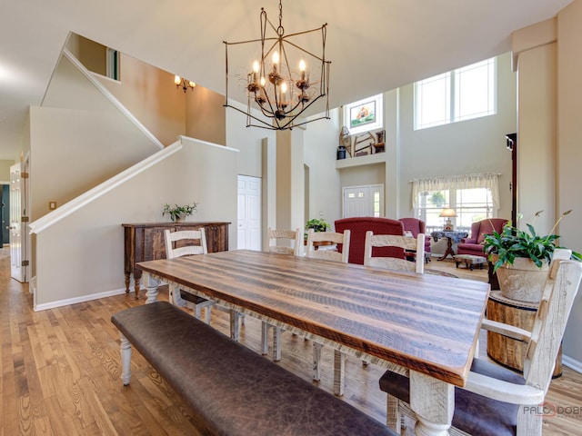 1341 N Home Ct, Palatine, IL 60074 - dining space with a towering ceiling, wood finished floors, stairway, baseboards, and a chandelier