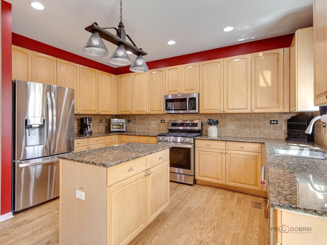 1341 N Home Ct, Palatine, IL 60074 - kitchen with stainless steel appliances, light brown cabinets, a sink, light wood finished floors, and a kitchen island
