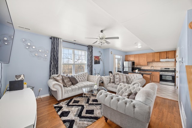 4221 Brentwood Ln, Waukegan, IL 60087 - living room with baseboards, ceiling fan, visible vents, and light wood-style flooring