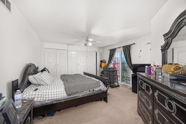 bedroom featuring visible vents, ceiling fan, a closet, and light colored carpet