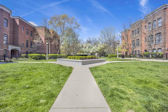 view of home's community featuring a yard and fence