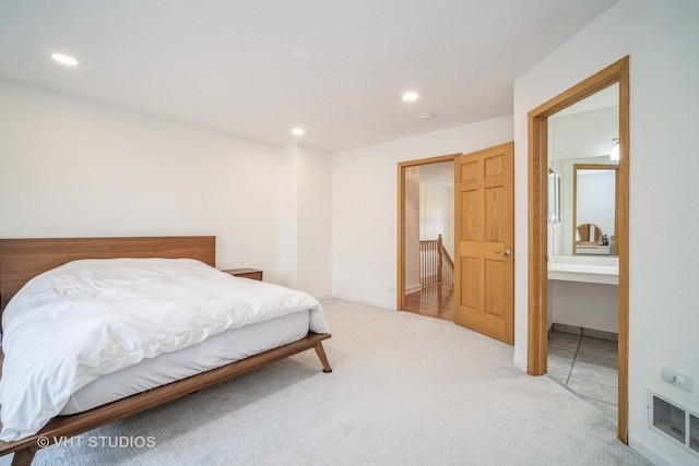 bedroom featuring light carpet, recessed lighting, and visible vents