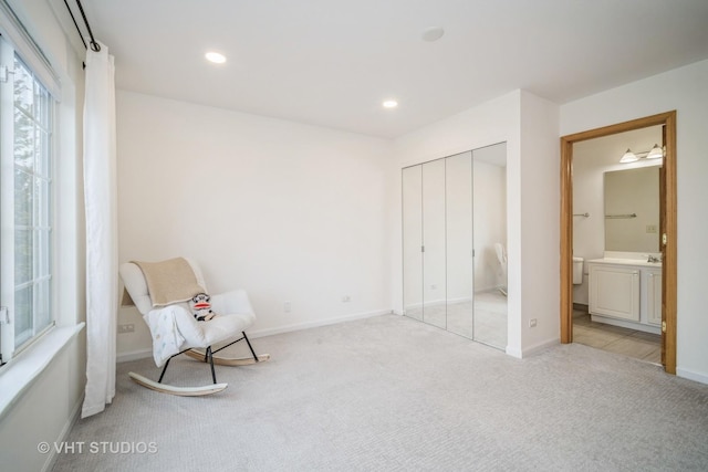 unfurnished room with recessed lighting, baseboards, and light carpet