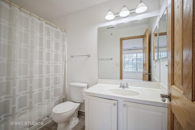 bathroom featuring vanity, a shower with shower curtain, visible vents, and toilet