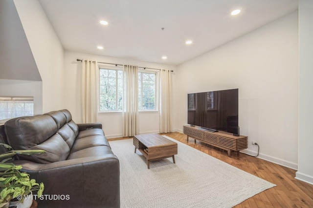 living room featuring baseboards, recessed lighting, and hardwood / wood-style floors