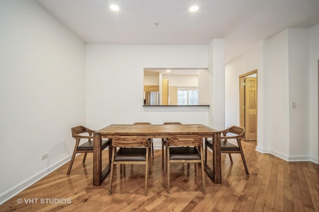 dining space with recessed lighting, baseboards, and hardwood / wood-style flooring