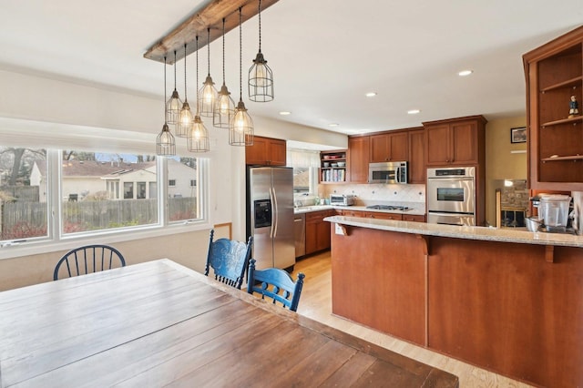 4569 Gettysburg Dr, Rolling Meadows, IL 60008 - kitchen with open shelves, appliances with stainless steel finishes, light wood-style floors, brown cabinetry, and decorative light fixtures