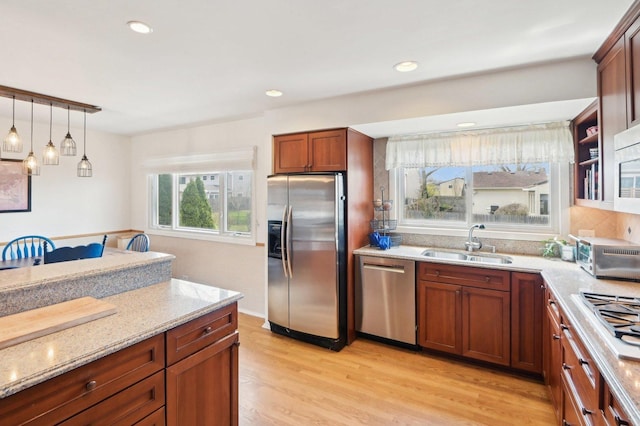 4569 Gettysburg Dr, Rolling Meadows, IL 60008 - kitchen with light stone countertops, appliances with stainless steel finishes, a sink, light wood finished floors, and a toaster