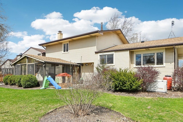 4569 Gettysburg Dr, Rolling Meadows, IL 60008 - rear view of house with a shingled roof, a yard, a chimney, and a sunroom