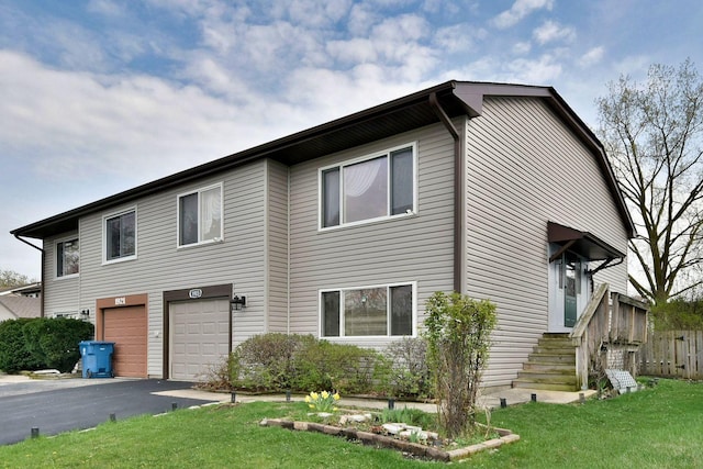 1923 Windward Ln Unit 1923, Hanover Park, IL 60133 - view of front of house featuring fence, an attached garage, driveway, and a front yard