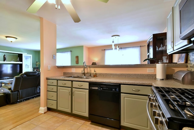 kitchen featuring a sink, stainless steel gas stove, dishwasher, a ceiling fan, and open floor plan