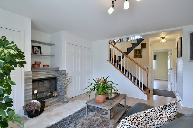 1923 Windward Ln Unit 1923, Hanover Park, IL 60133 - living area with tile patterned floors, a tiled fireplace, baseboards, and stairway