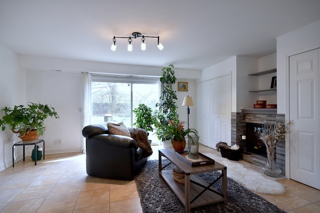 1923 Windward Ln Unit 1923, Hanover Park, IL 60133 - living room featuring baseboards, a stone fireplace, and light tile patterned floors