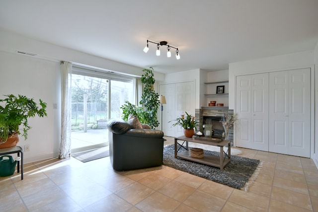 1923 Windward Ln Unit 1923, Hanover Park, IL 60133 - living room featuring track lighting, a fireplace, and visible vents