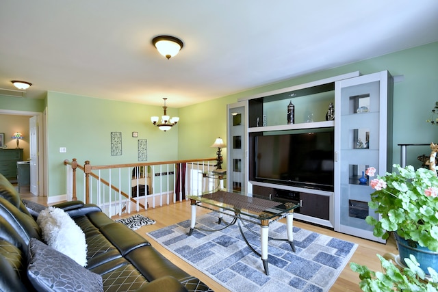 1923 Windward Ln Unit 1923, Hanover Park, IL 60133 - living room featuring wood finished floors and a notable chandelier