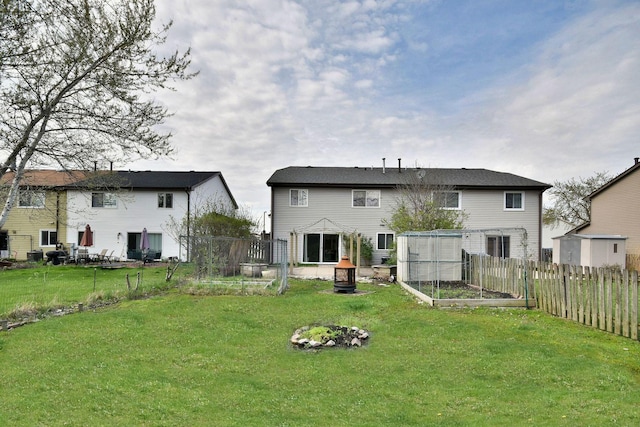 1923 Windward Ln Unit 1923, Hanover Park, IL 60133 - rear view of property with fence, a yard, and a garden