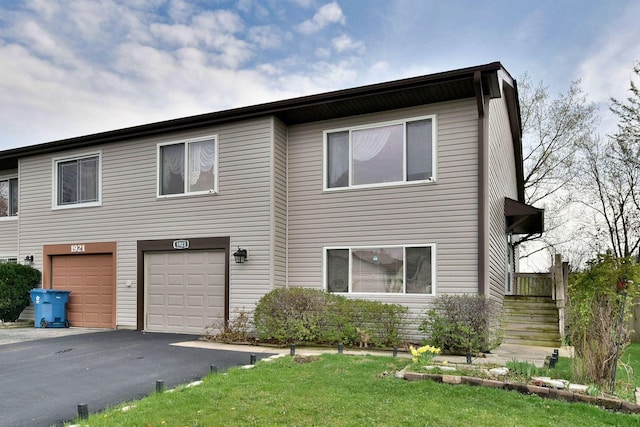 multi unit property featuring a garage and aphalt driveway