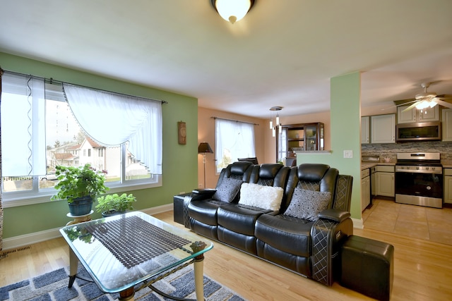 1923 Windward Ln Unit 1923, Hanover Park, IL 60133 - living area featuring baseboards, a ceiling fan, light wood finished floors, and visible vents