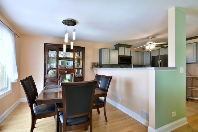 1923 Windward Ln Unit 1923, Hanover Park, IL 60133 - dining room with visible vents, light wood-style flooring, ceiling fan, and baseboards