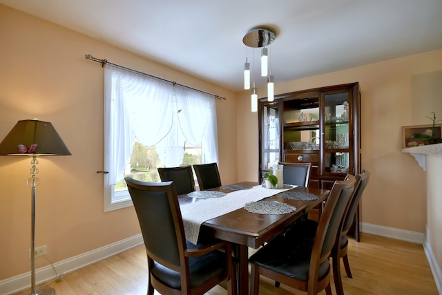 1923 Windward Ln Unit 1923, Hanover Park, IL 60133 - dining room featuring baseboards, a healthy amount of sunlight, and light wood-type flooring