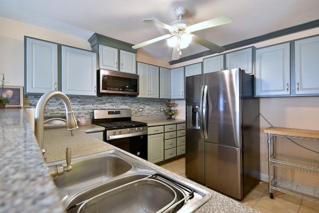 1923 Windward Ln Unit 1923, Hanover Park, IL 60133 - kitchen with a ceiling fan, backsplash, light tile patterned floors, light countertops, and stainless steel appliances