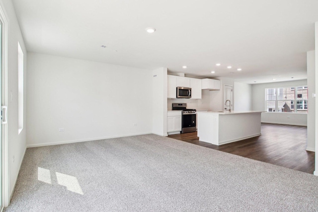 6343 Ulster Dr, Tinley Park, IL 60477 - kitchen with dark carpet, open floor plan, appliances with stainless steel finishes, and a kitchen island with sink