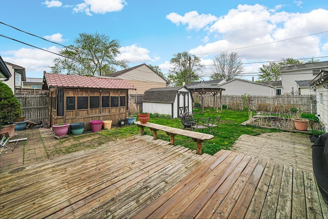 19605 Redwood Ln, Mokena, IL 60448 - deck with an outdoor structure, a fenced backyard, and a storage unit