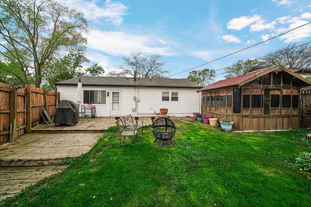 19605 Redwood Ln, Mokena, IL 60448 - back of house with a deck, a fire pit, fence, and a lawn