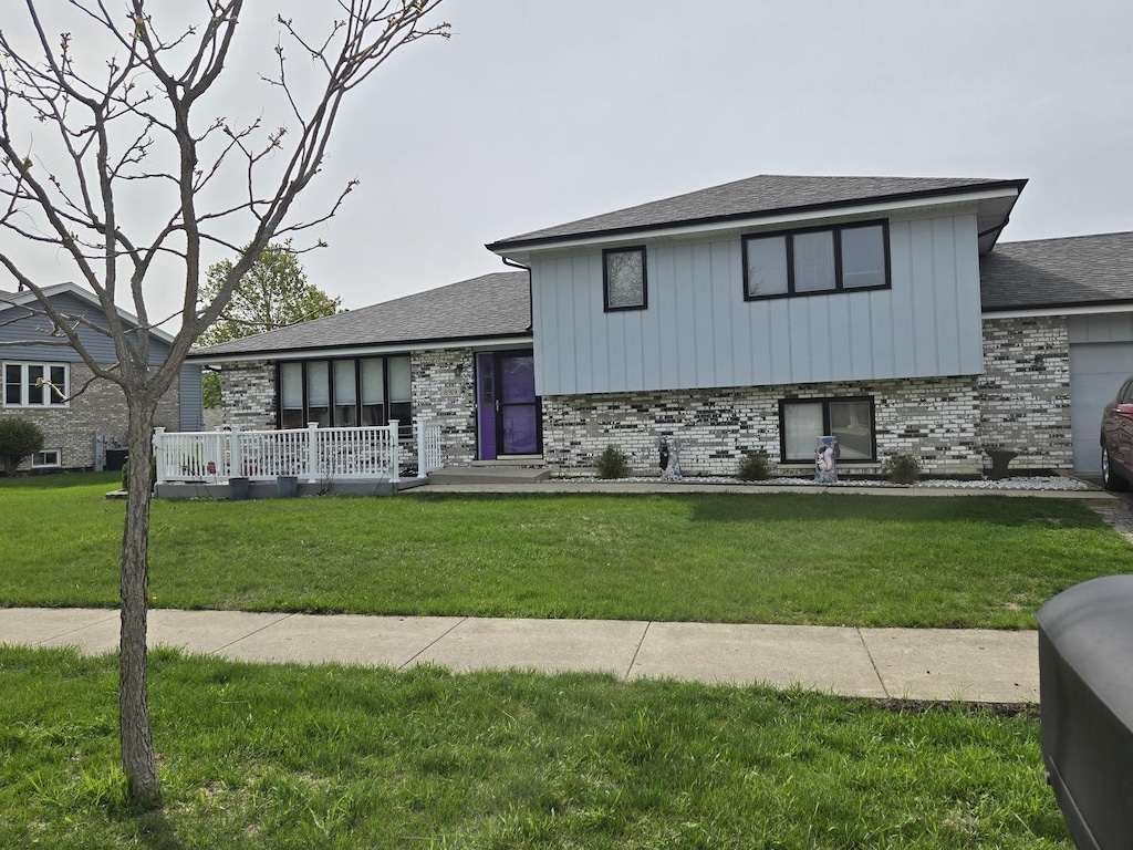 8919 Meadowview Dr, Orland Hills, IL 60487 - tri-level home with board and batten siding, brick siding, and a front lawn