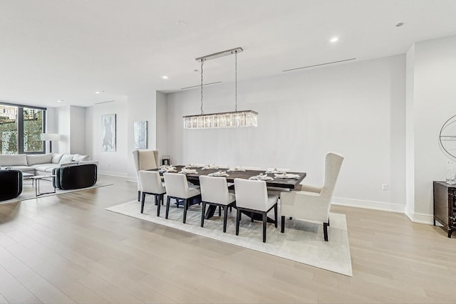 dining room with recessed lighting, baseboards, and light wood-type flooring