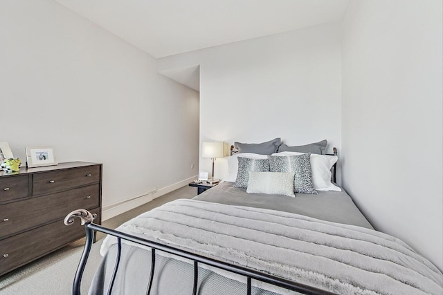 carpeted bedroom featuring baseboards