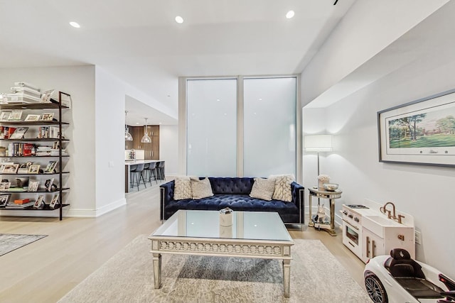 living area featuring baseboards, recessed lighting, and wood finished floors