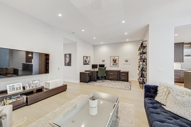 living area with light wood-style floors, baseboards, and recessed lighting
